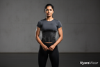 “High-impact, photorealistic hero image for a premium fitness brand. An Indian woman stands confidently in a modern, minimal studio, wearing a wide black rubber sweat band that fully covers the entire belly from under the bust to the lower abdomen. The band wraps smoothly around the stomach and sides, showing a subtle sweat and heat effect. Powerful posture, calm confidence, soft dramatic lighting, clean background. Premium, bold, modern, and empowering brand aesthetic.” branding nane vyarawear