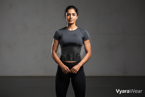 “High-impact, photorealistic hero image for a premium fitness brand. An Indian woman stands confidently in a modern, minimal studio, wearing a wide black rubber sweat band that fully covers the entire belly from under the bust to the lower abdomen. The band wraps smoothly around the stomach and sides, showing a subtle sweat and heat effect. Powerful posture, calm confidence, soft dramatic lighting, clean background. Premium, bold, modern, and empowering brand aesthetic.” branding nane vyarawear